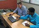 Powell Tronics’ Andre Joubert trains Siyabonga Mbeleka on the ATOM suite of products.